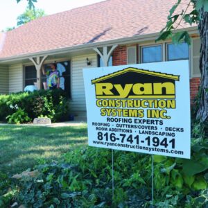 Ryan Construction Systems yard sign in front of a Kansas City home with a new roof installation.