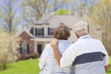 photo of happy couple in front of new roof