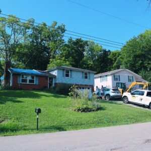 Kansas City home with a blue tarp covering the roof during storm damage repair by Ryan Construction Systems.