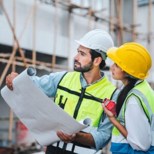 Experienced Kansas City roofing contractors reviewing blueprints on a residential construction site in Parkville.