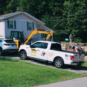Ryan Construction Systems truck and equipment parked at a Kansas City job site during roof replacement work.