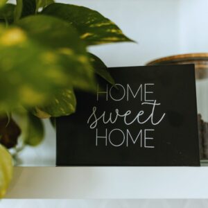 Close-up of ‘Home Sweet Home’ sign with houseplants—symbolizing the comfort of quality home remodeling in Kansas City.