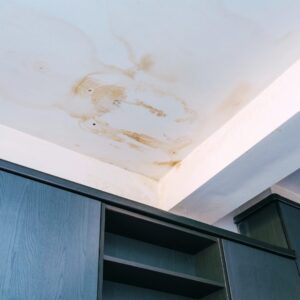 Water-stained ceiling inside a home, showing signs of a roof leak and the importance of fall roof inspections and winter weather preparation in Kansas City.