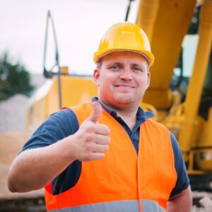 Confident roofing contractor in safety gear giving a thumbs up, representing trusted fall roofing services and winter prep for Kansas City homeowners.