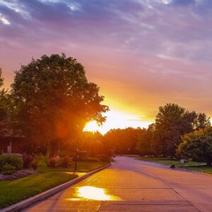 Peaceful Kansas City suburban neighborhood at sunset, ideal for residential roofing and exterior services.