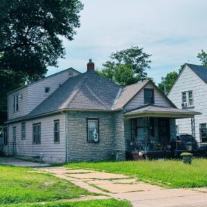 A residential house in Kansas City with a newly installed roof, showcasing professional roofing services.
